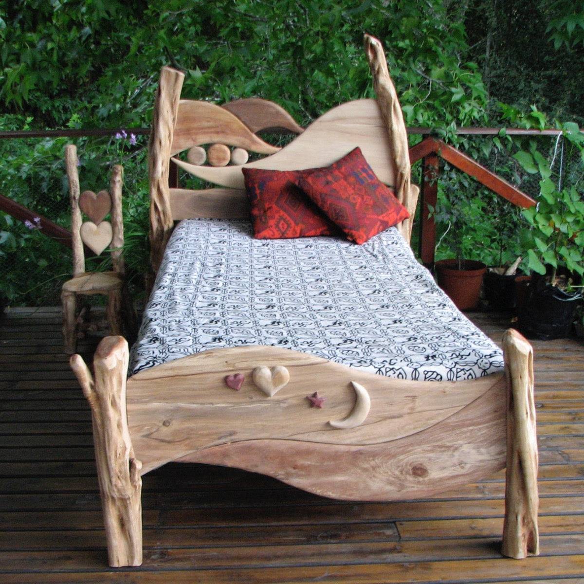 Close-up of carved wave headboard on driftwood bed — handmade oak fantasy bed, Wales