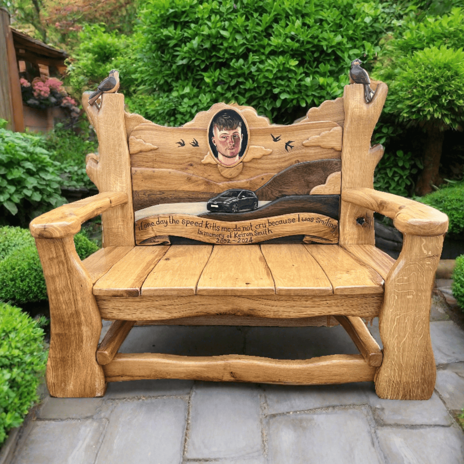Beautifully handcrafted oak memorial bench with personalised portrait carvings and symbolic birds — bespoke garden tribute, Wales