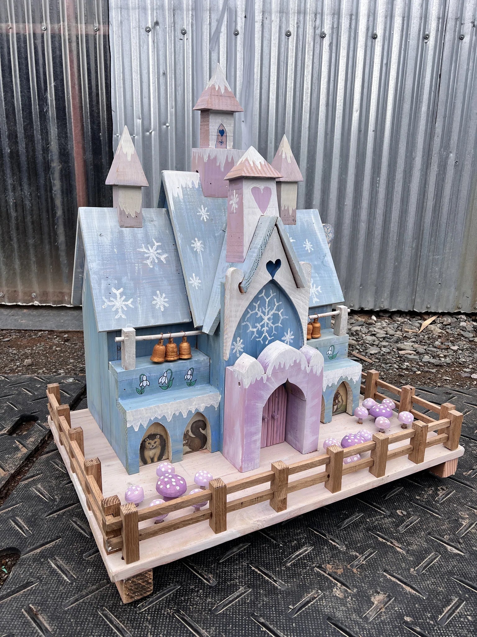 Close-up detail of ice palace fairy house windows with hand-painted snowflake and frost decorations