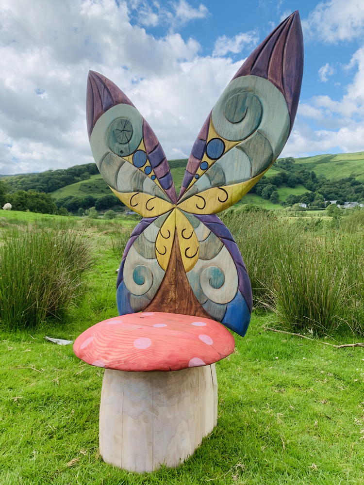 Side view of fairy chair with butterfly wings in nature