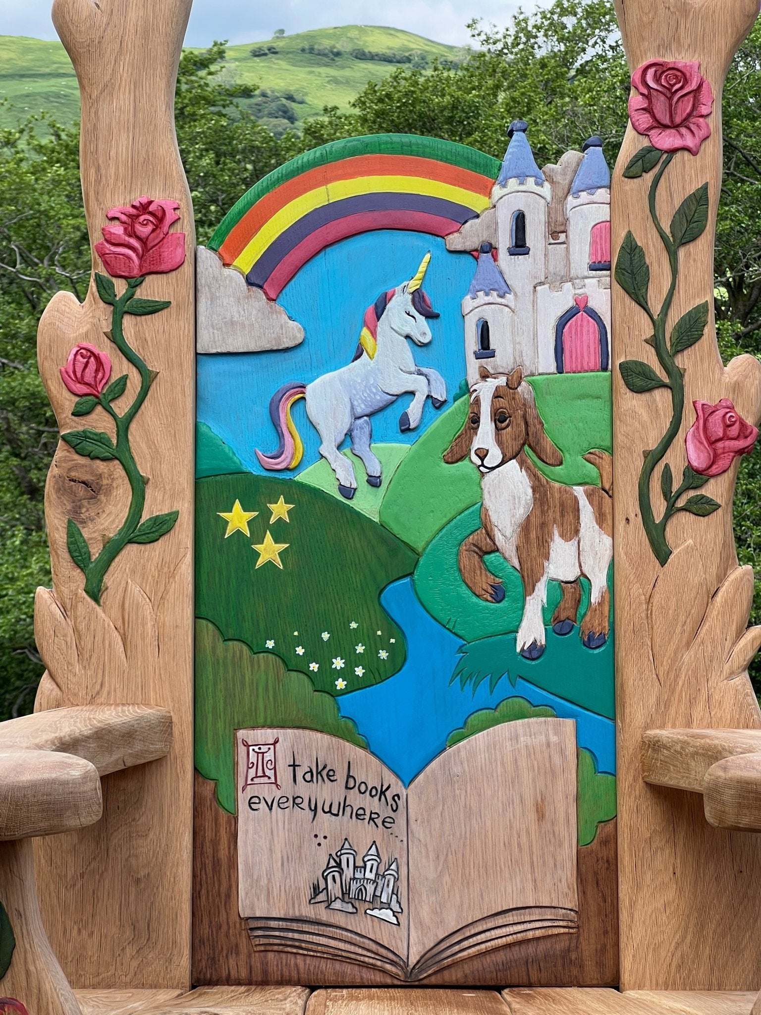 Carved fantasy unicorn background on handmade oak fairytale storytelling chair — bespoke school furniture, Wales