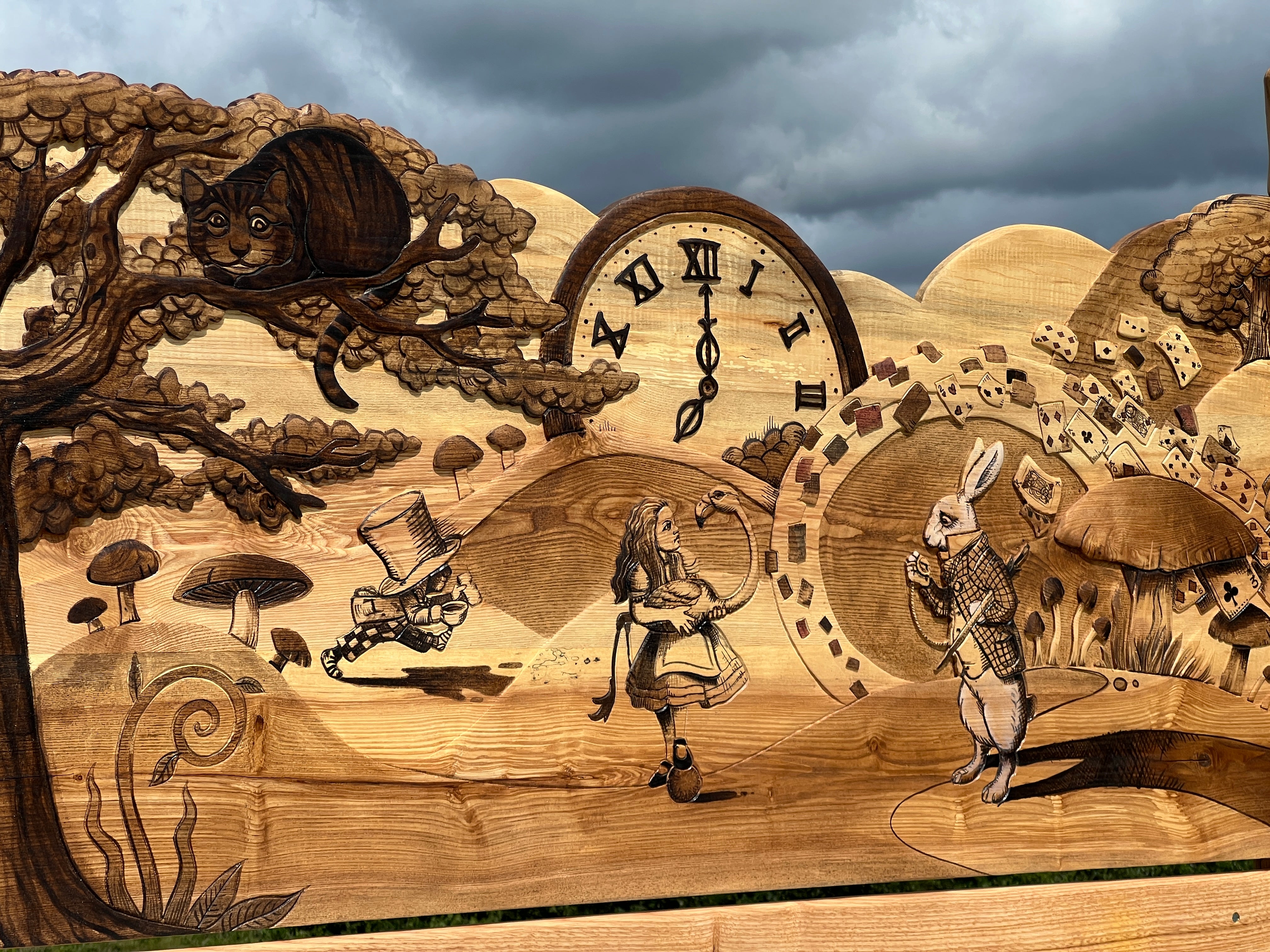 Cheshire Cat in tree with Alice and White Rabbit engraved into fantasy wooden bed


