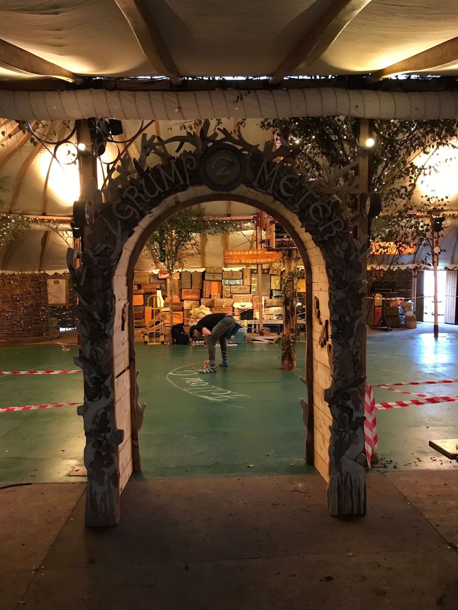 Decorative archway with 'Grump Meter' text in a warehouse setting