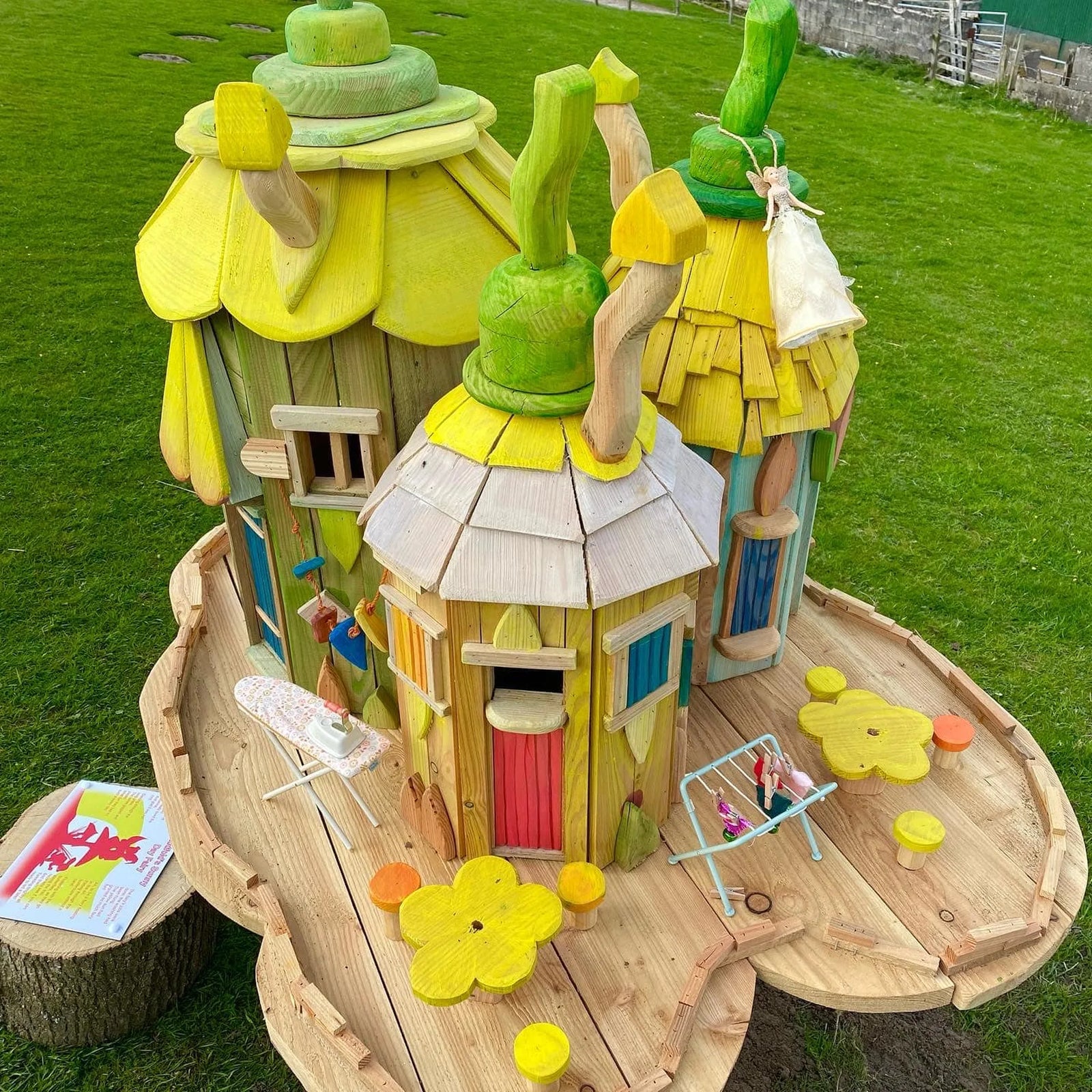 Handmade botanical flower village fairy house with hand-painted floral details across clustered buildings
