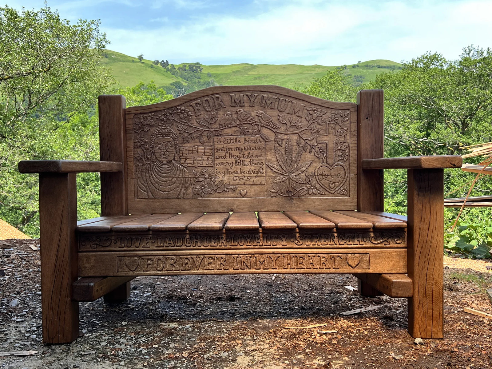 For My Mum memorial bench in solid oak, front view with chunky frame and detailed carved backrest