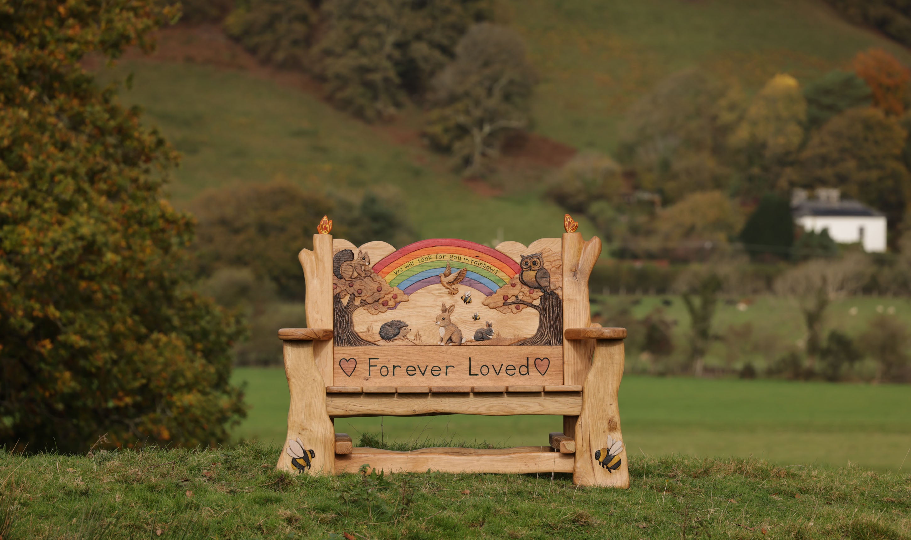 handcarved oak bench with rainbow inscription we will look for you in rainbows