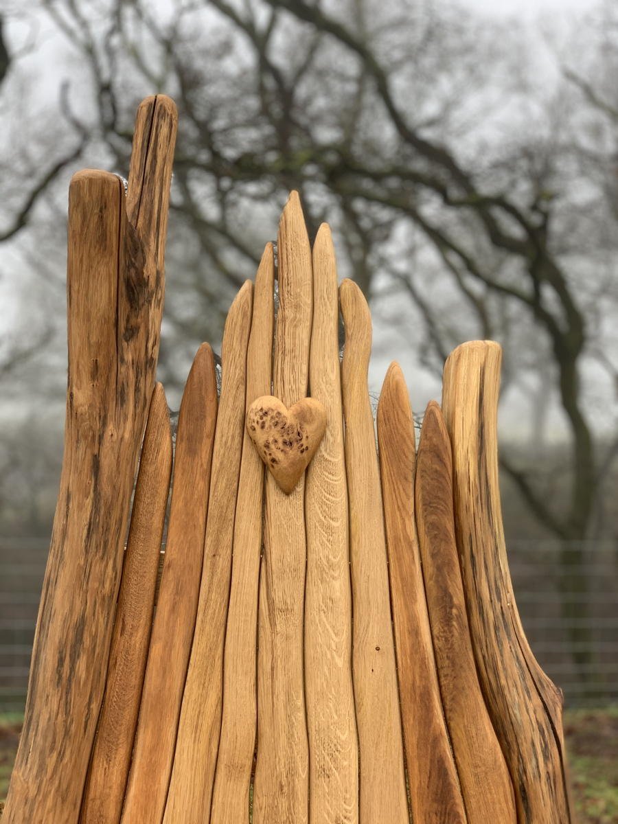 Carved oak backrest on handmade giant garden bench — bespoke 2-seater outdoor seating, Wales