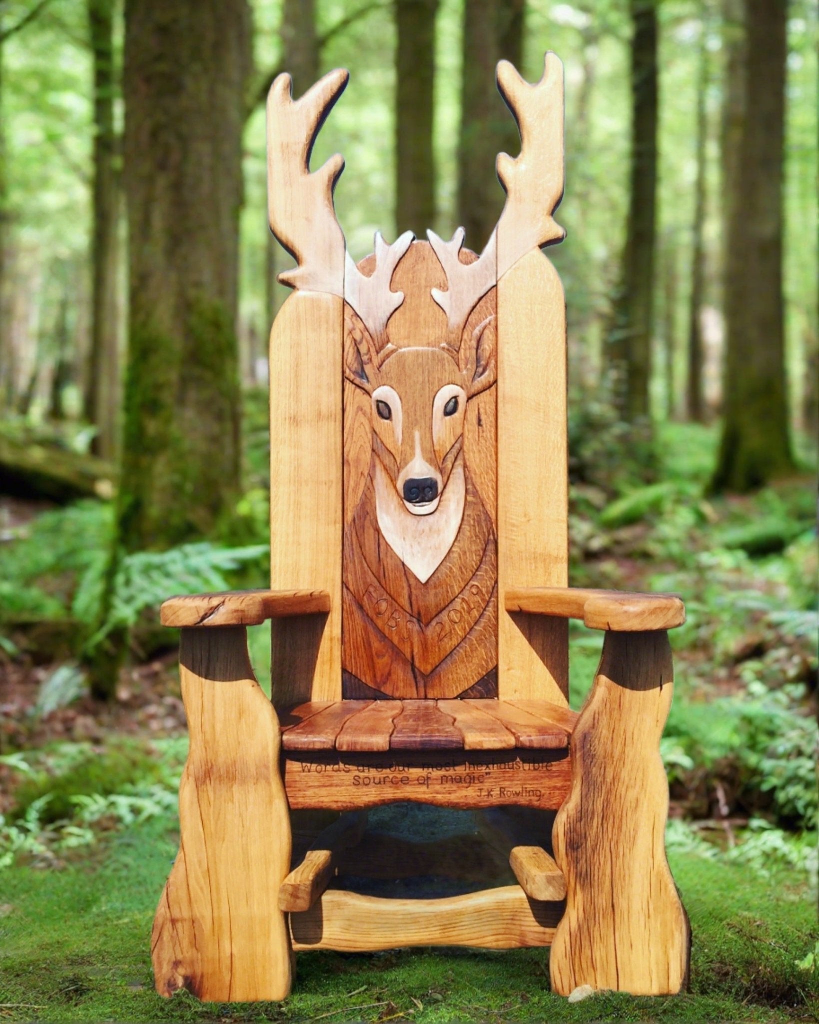 Wooden chair with deer carving in a forest setting.