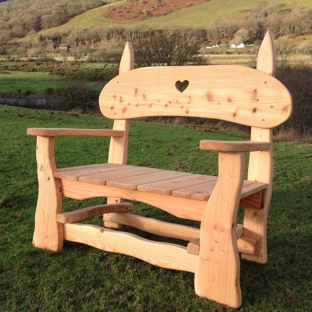 Rustic hand-carved wooden garden bench made from sustainable Cedar and Douglas Fir, designed for outdoor comfort and style.

