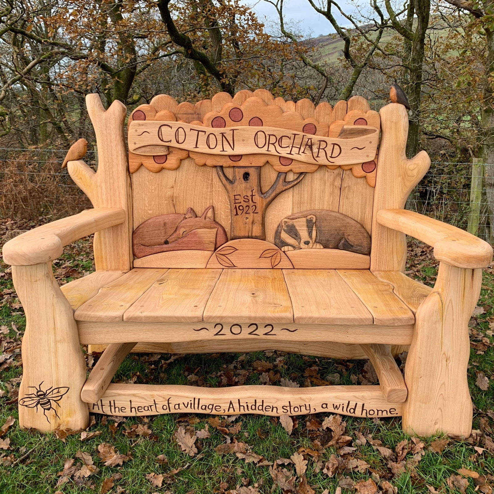 Handcrafted Coton Orchard Bench featuring wildlife carvings and a rustic design, celebrating heritage and nature — handmade in Wales