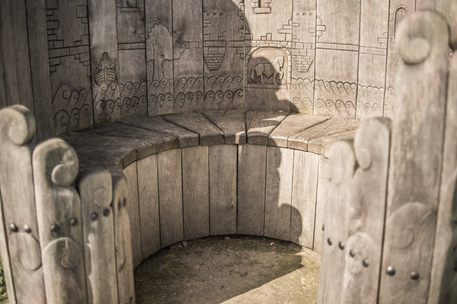 Wood carving detail on handmade circular oak bench — Harlech Castle-inspired, Wales