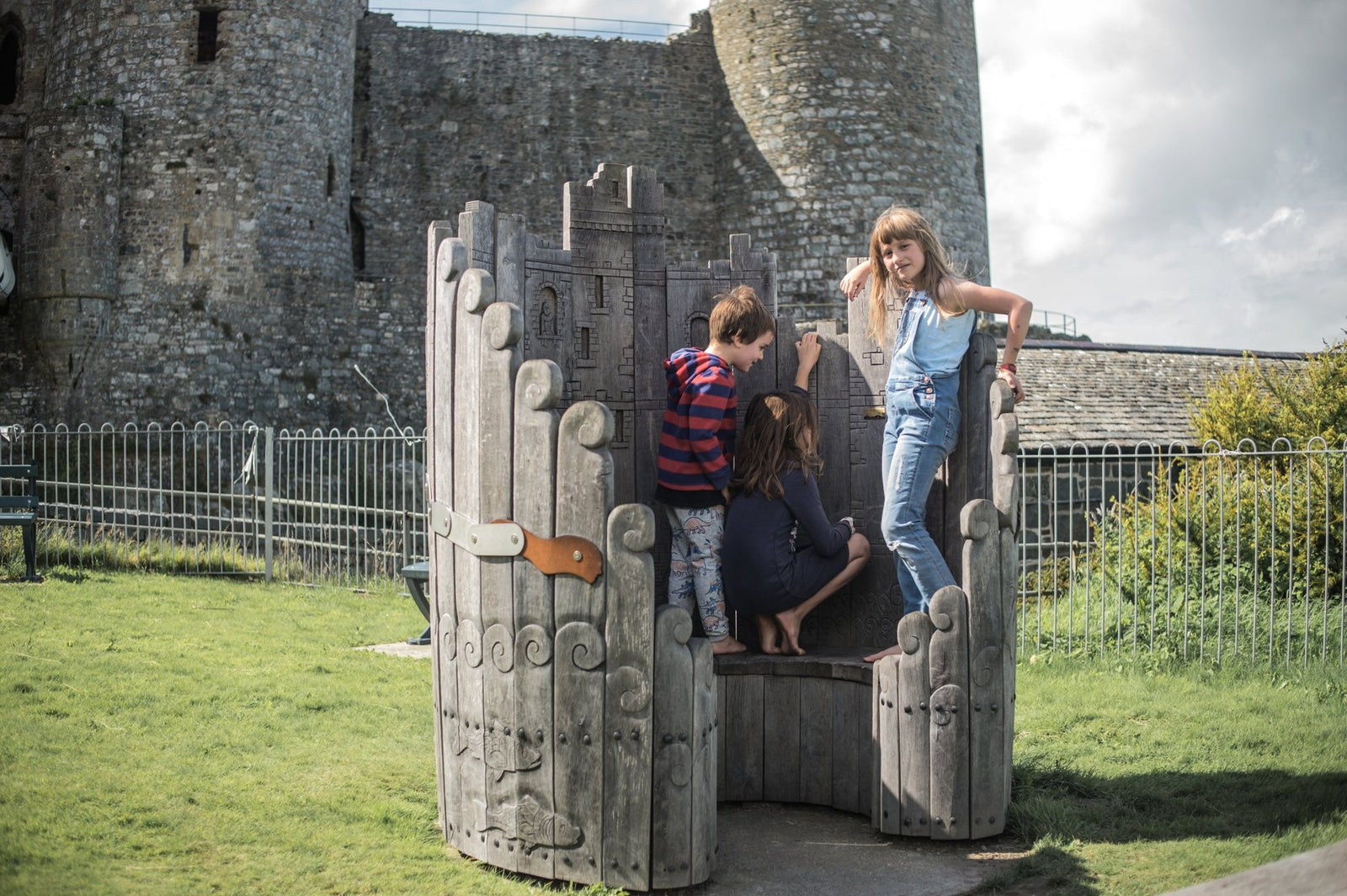 Kids playing on handmade giant circular oak bench — bespoke, Wales