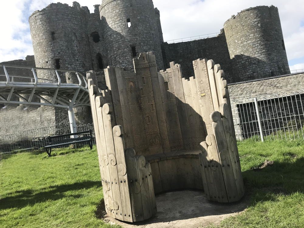 Harlech Castle carved circular oak bench — handmade bespoke, Wales