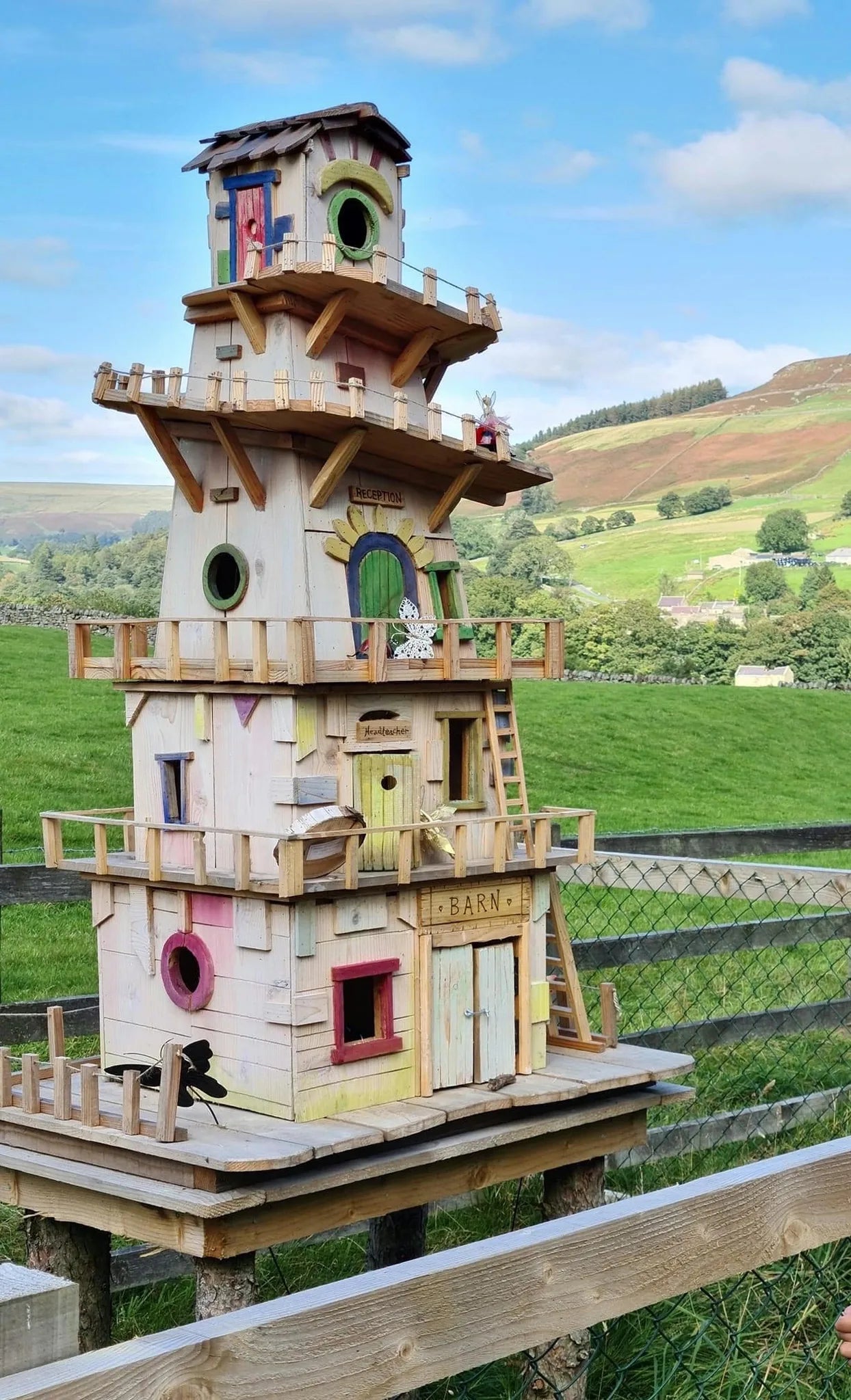 Side view of helter skelter fairy tower showing multiple floors and colourful fairground paintwork