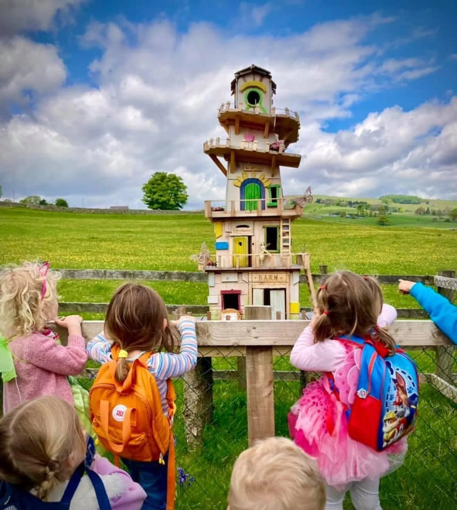 Upper storeys of helter skelter fairy village showing painted spiral and balcony details