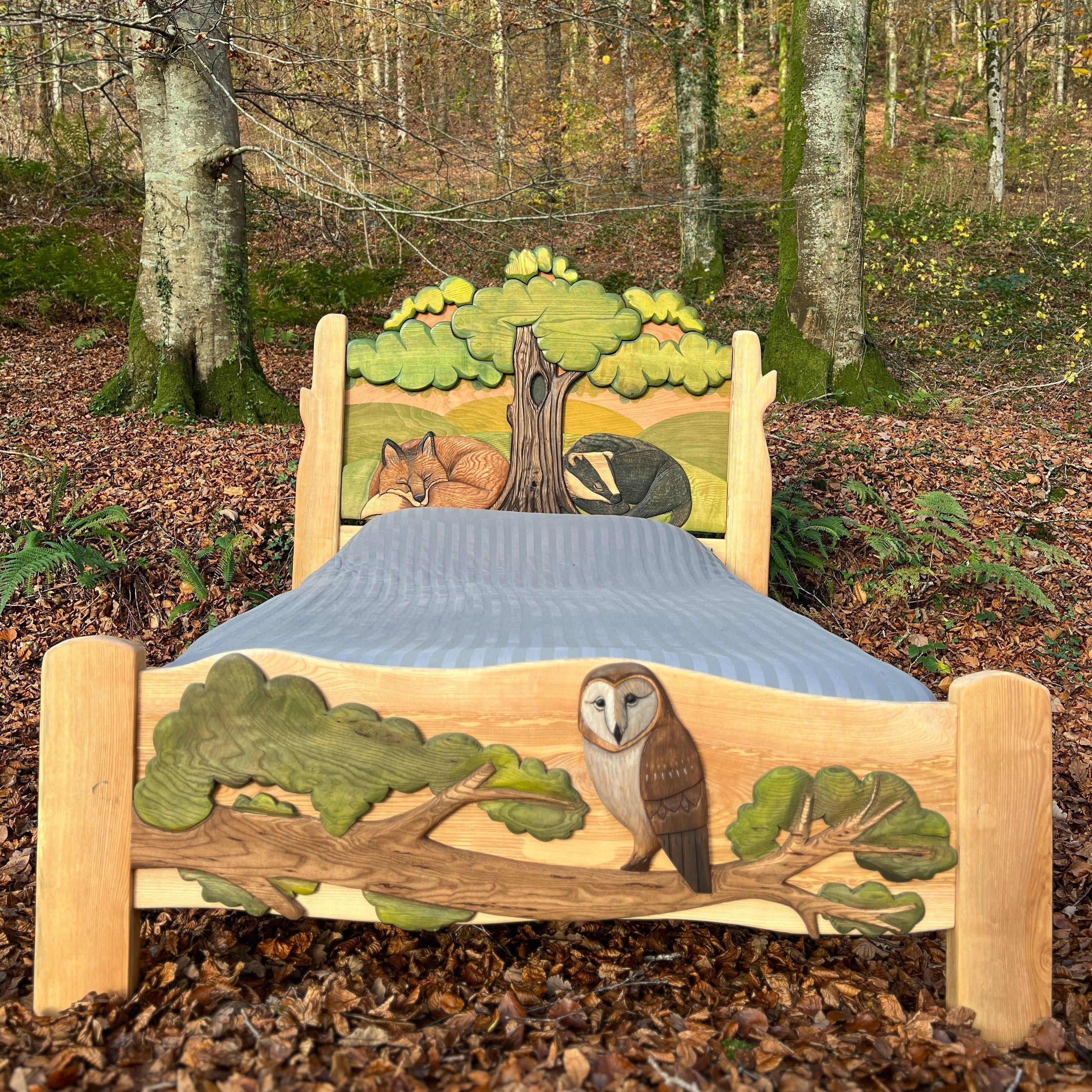 Handcrafted kids animal bed featuring a fox, badger, and owl carved into a woodland-themed design, perfect for a nature-inspired children's bedroom.