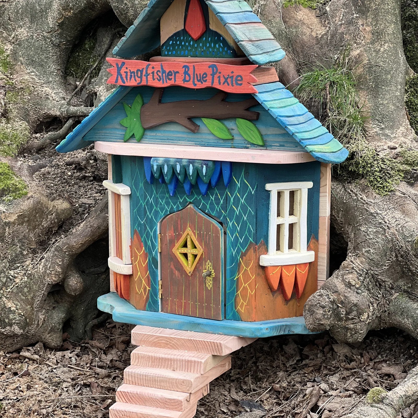 Handmade kingfisher blue pixie house with jewel-bright blue paintwork, tiny fairy door and wooden details