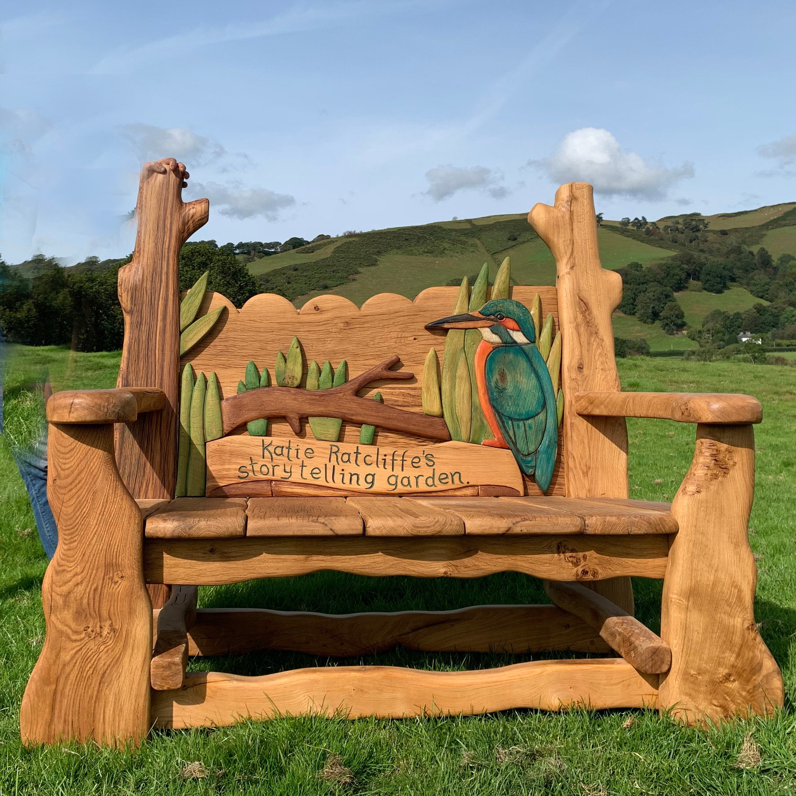 A handcrafted Kingfisher Memorial Bench with intricate carvings of a kingfisher, designed for wildlife gardens, nature reserves, and outdoor remembrance spaces.

