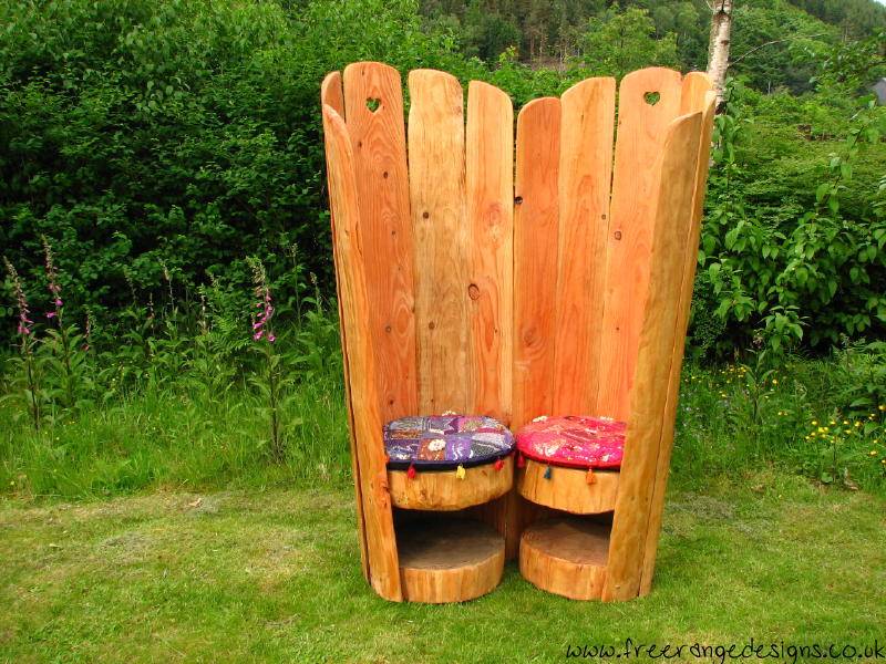 Oak story chairs in garden setting — handcrafted love seat furniture, Wales