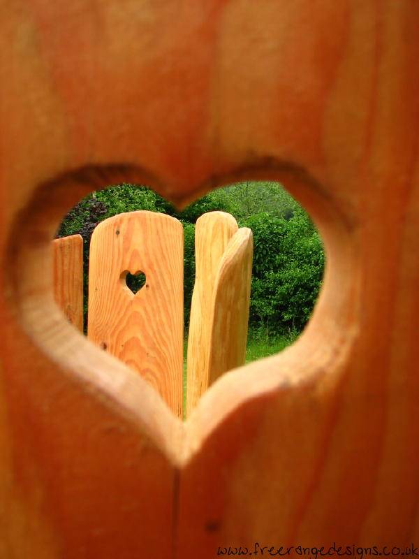 Carved oak love chair with heart detail — handmade kissing chair, Wales