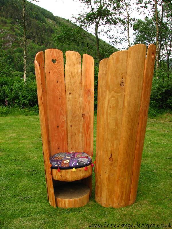 Carved oak love chairs facing each other — bespoke garden furniture, Wales