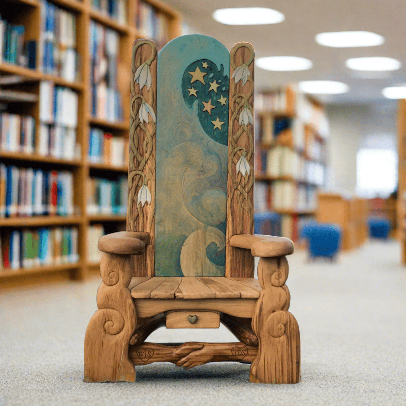 Handmade storyteller's chair in library setting — carved oak, bespoke, Wales