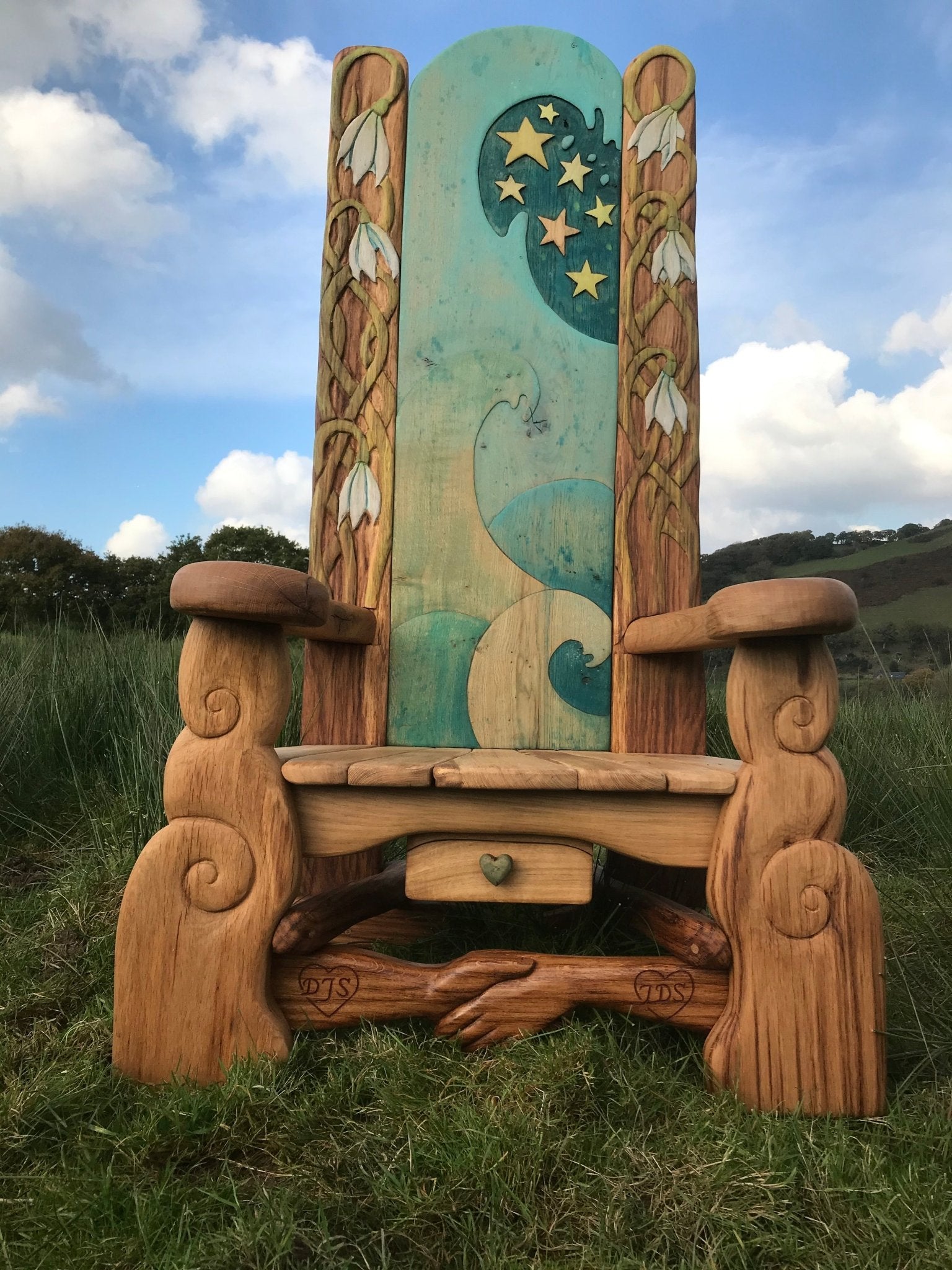 Handmade decorative story time chair on grassy field — carved oak, Wales