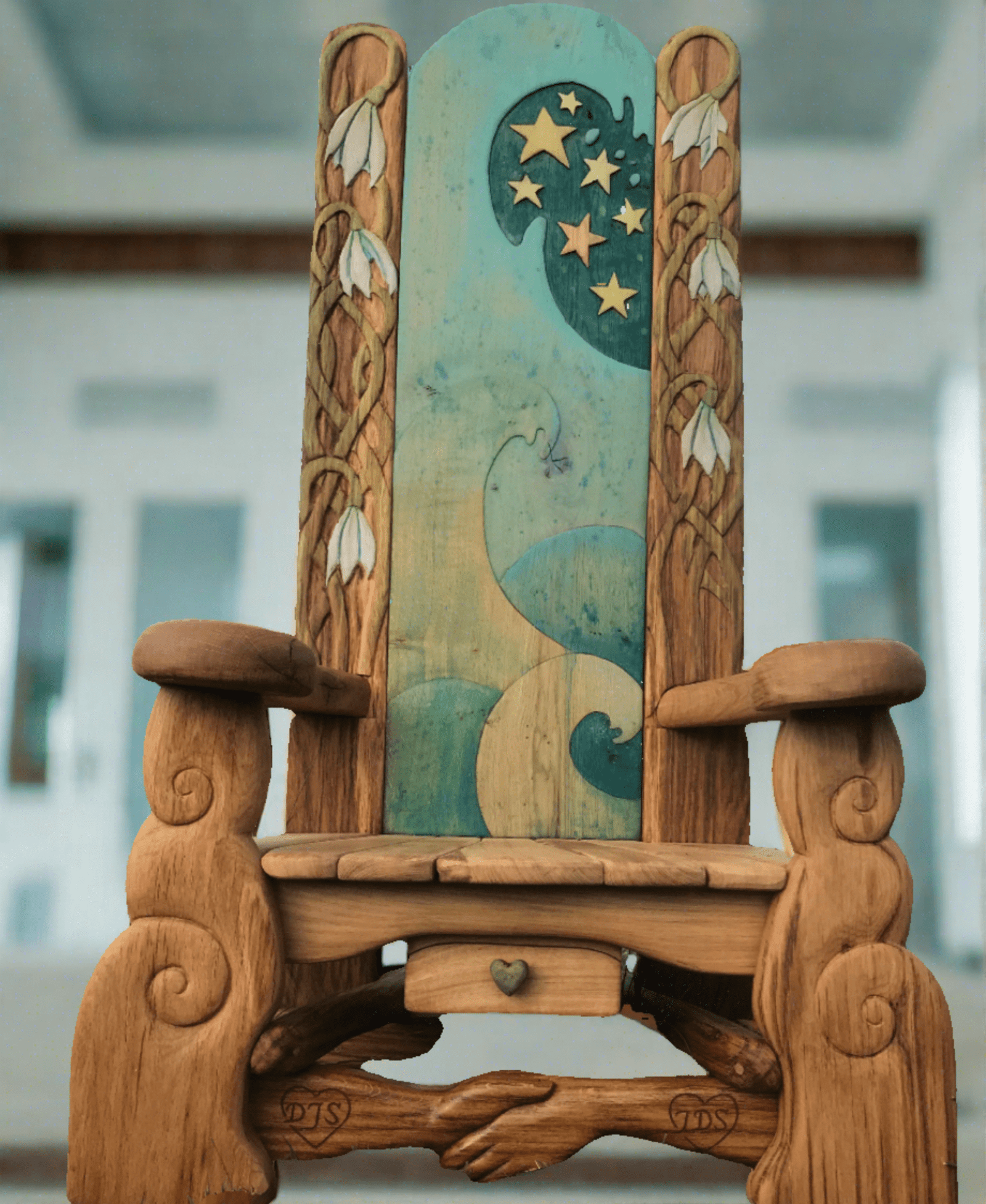 Handmade artistic storytelling chair indoors — carved oak, bespoke, Wales
