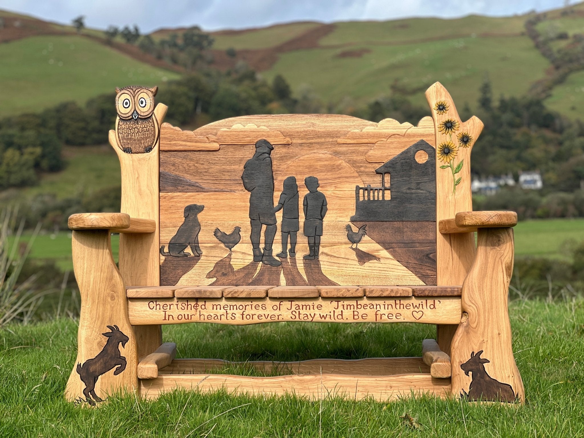 Closeup of personalised memorial bench with family silhouette 