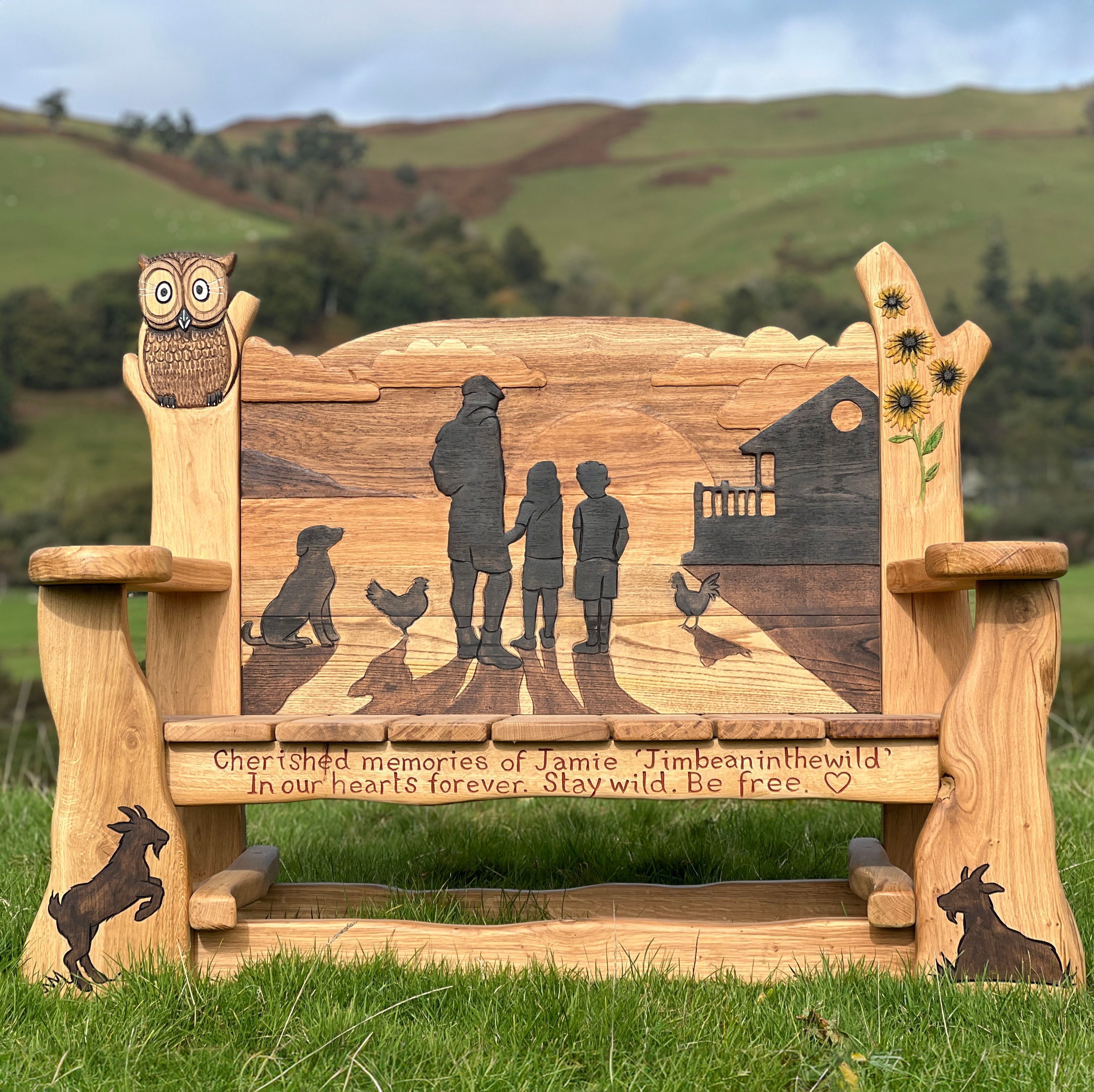 oak memorial bench with engraved inscription and wildlife carvings