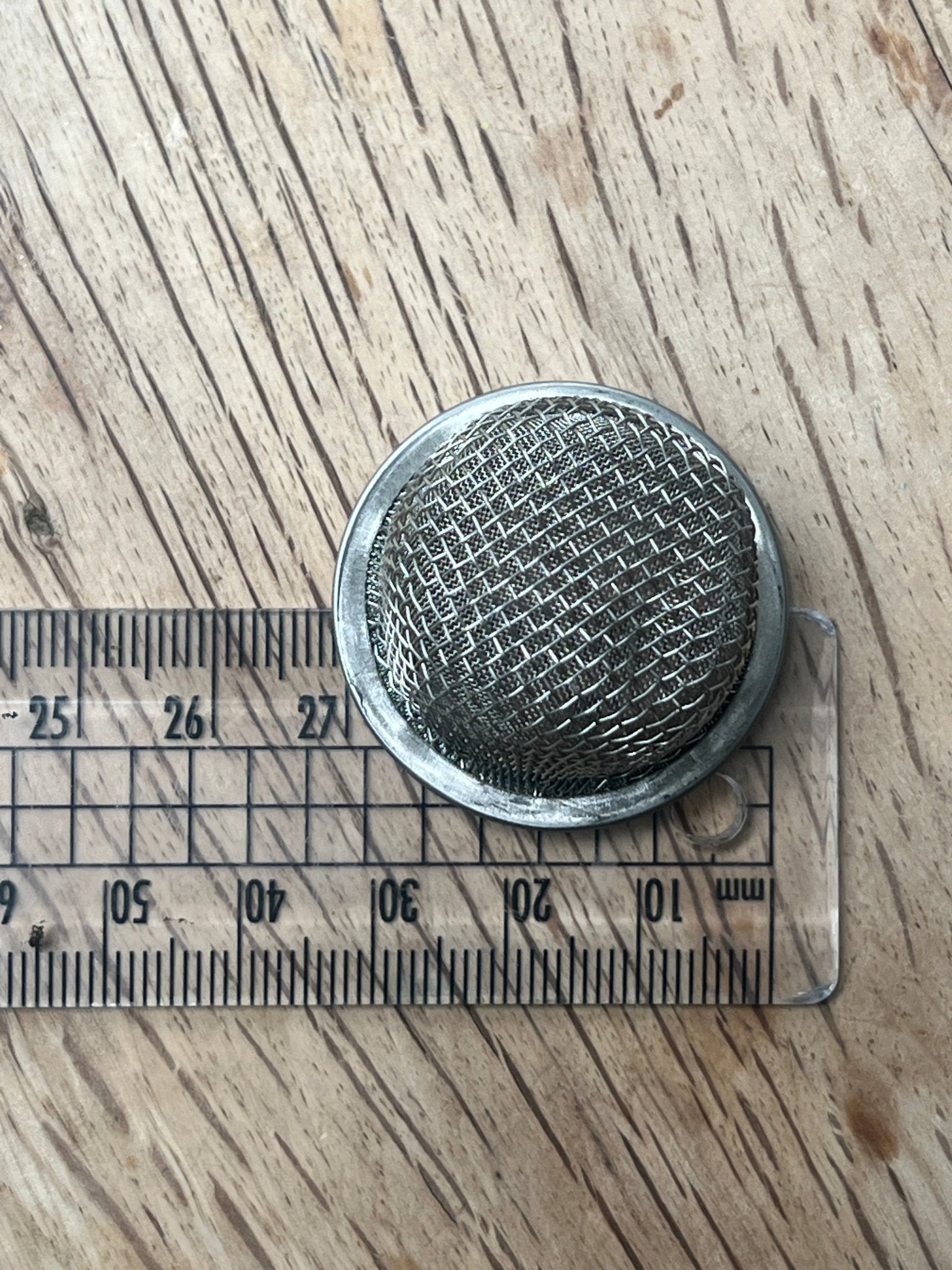 Close-up of metal mesh filter for composting toilet urine separator — eco sanitation
