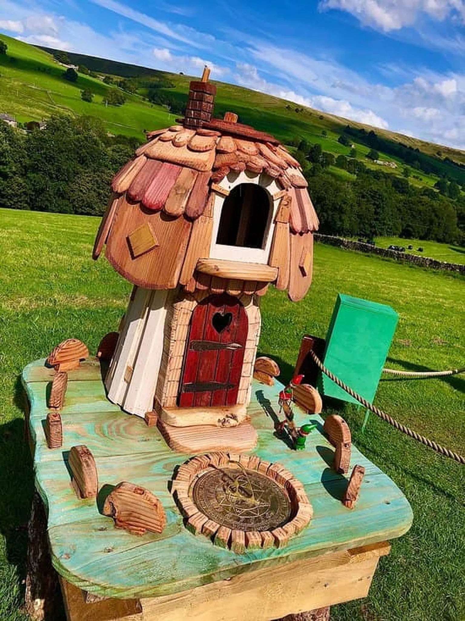 Close-up detail of mushroom fairy cottage door and window with hand-painted woodland decorations
