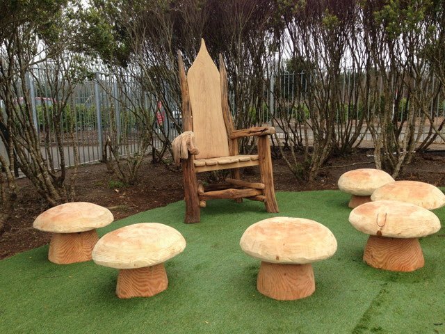 Handmade wooden throne surrounded by carved oak mushroom stools — bespoke, Wales