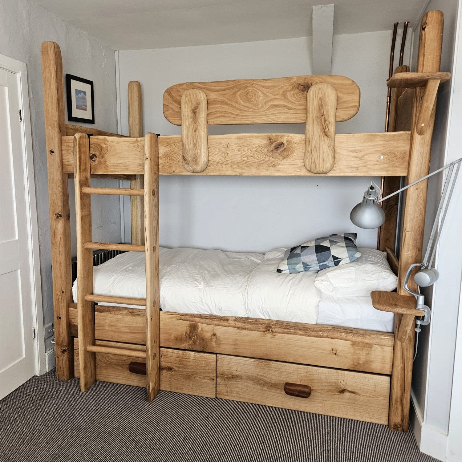 Handmade oak and driftwood bunk beds with a rustic design, showcasing eco-friendly materials, durability, and space-saving features for kids' bedrooms.