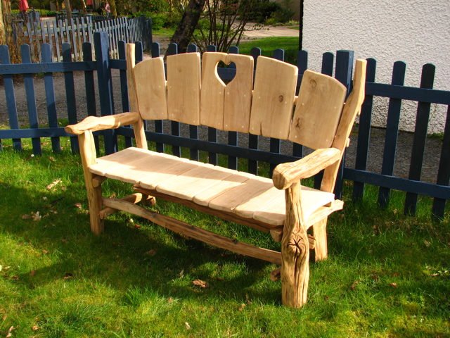 Handcrafted rustic oak heart fan bench in garden — bespoke outdoor seating, Wales