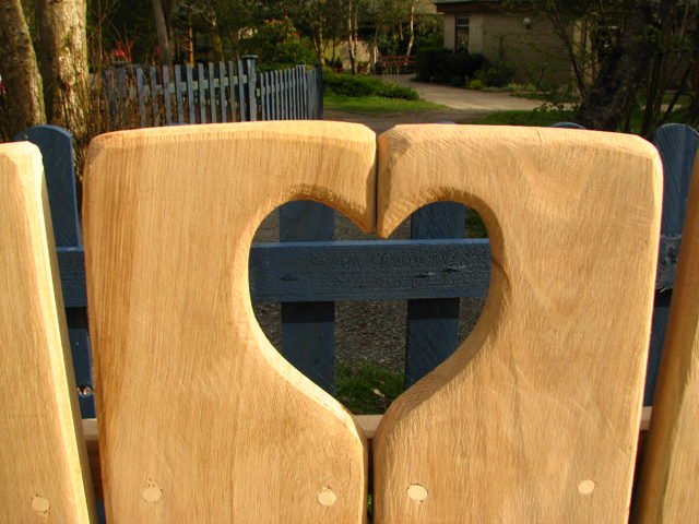 Carved oak heart garden bench — handmade bespoke outdoor park seating, Wales