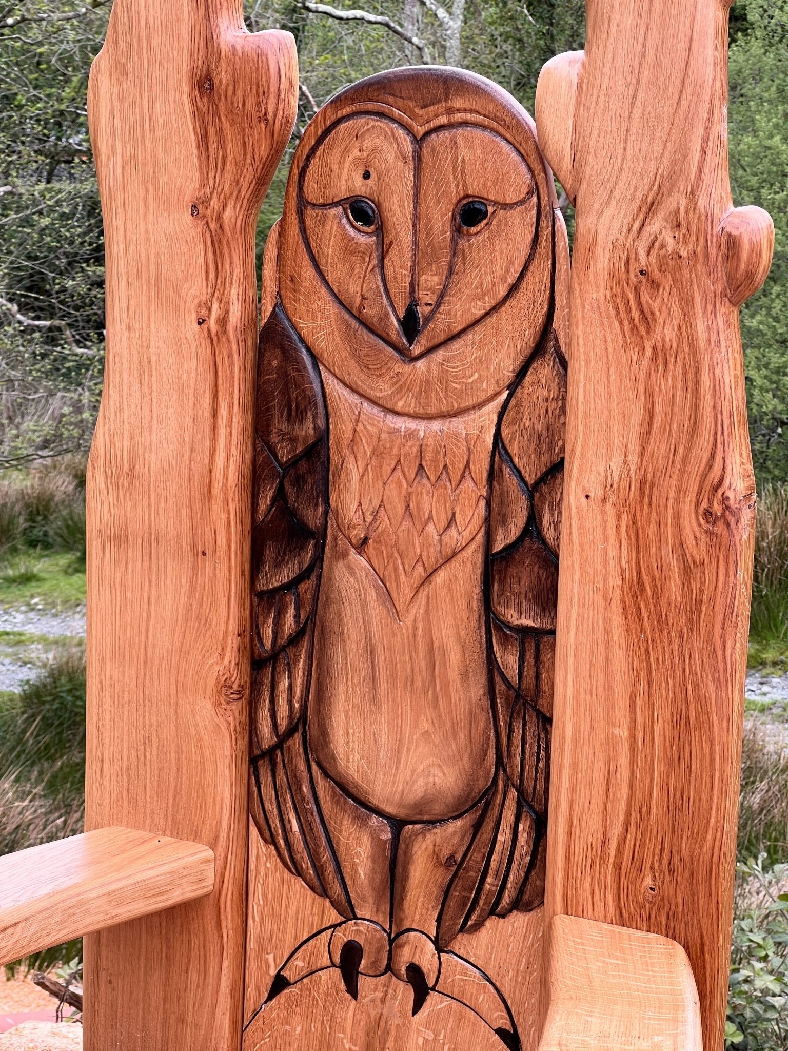 Close-up of hand-carved owl detail on oak storytelling chair backrest – handmade in Mid Wales