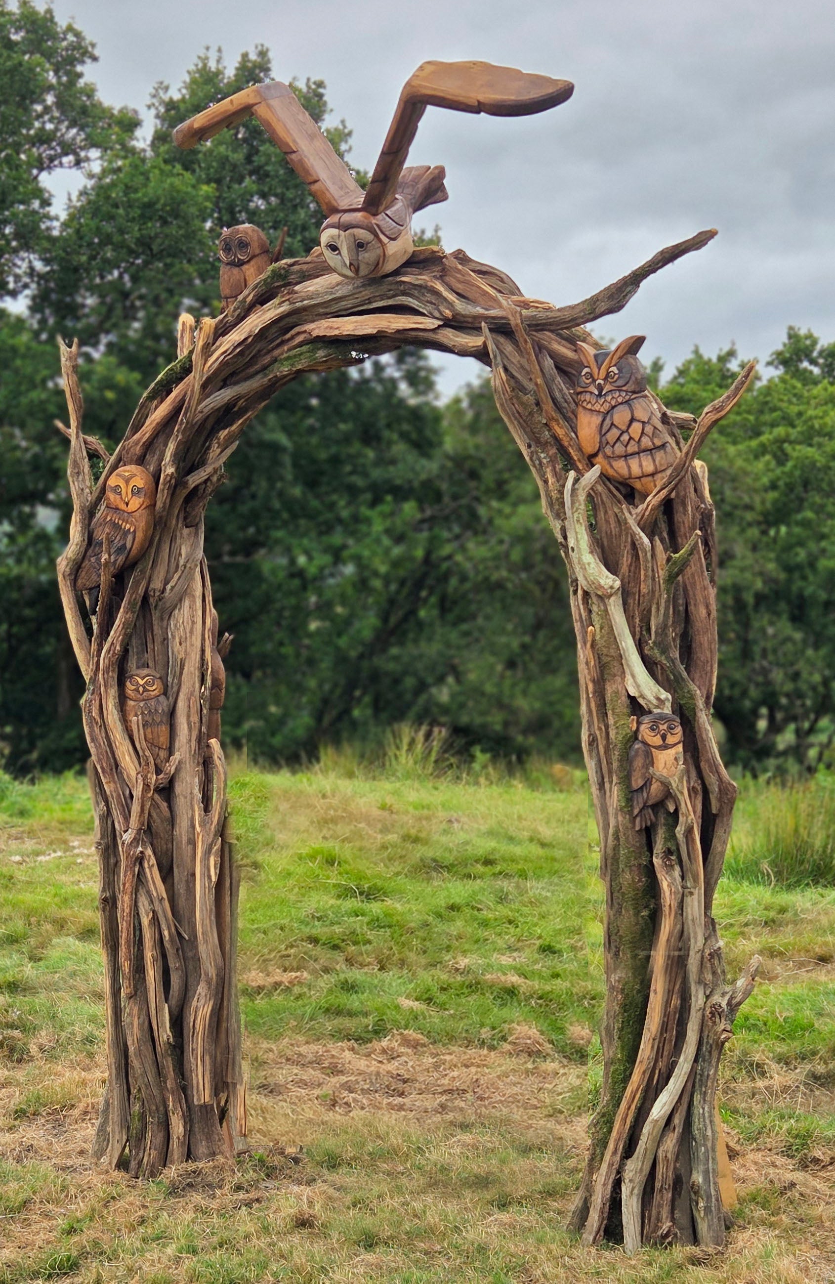 Wooden arch with animal figures in a natural setting