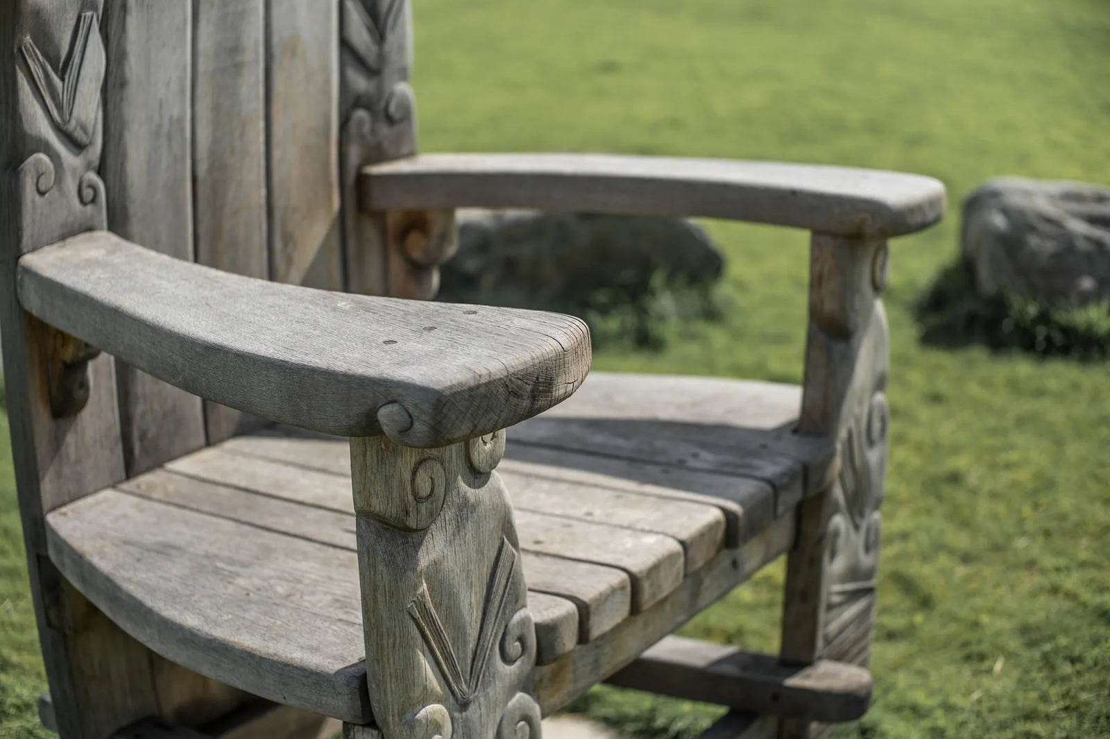 Carved oak armrest and seat detail of the Pen Y Graig storytelling throne | solid Welsh oak craftsmanship