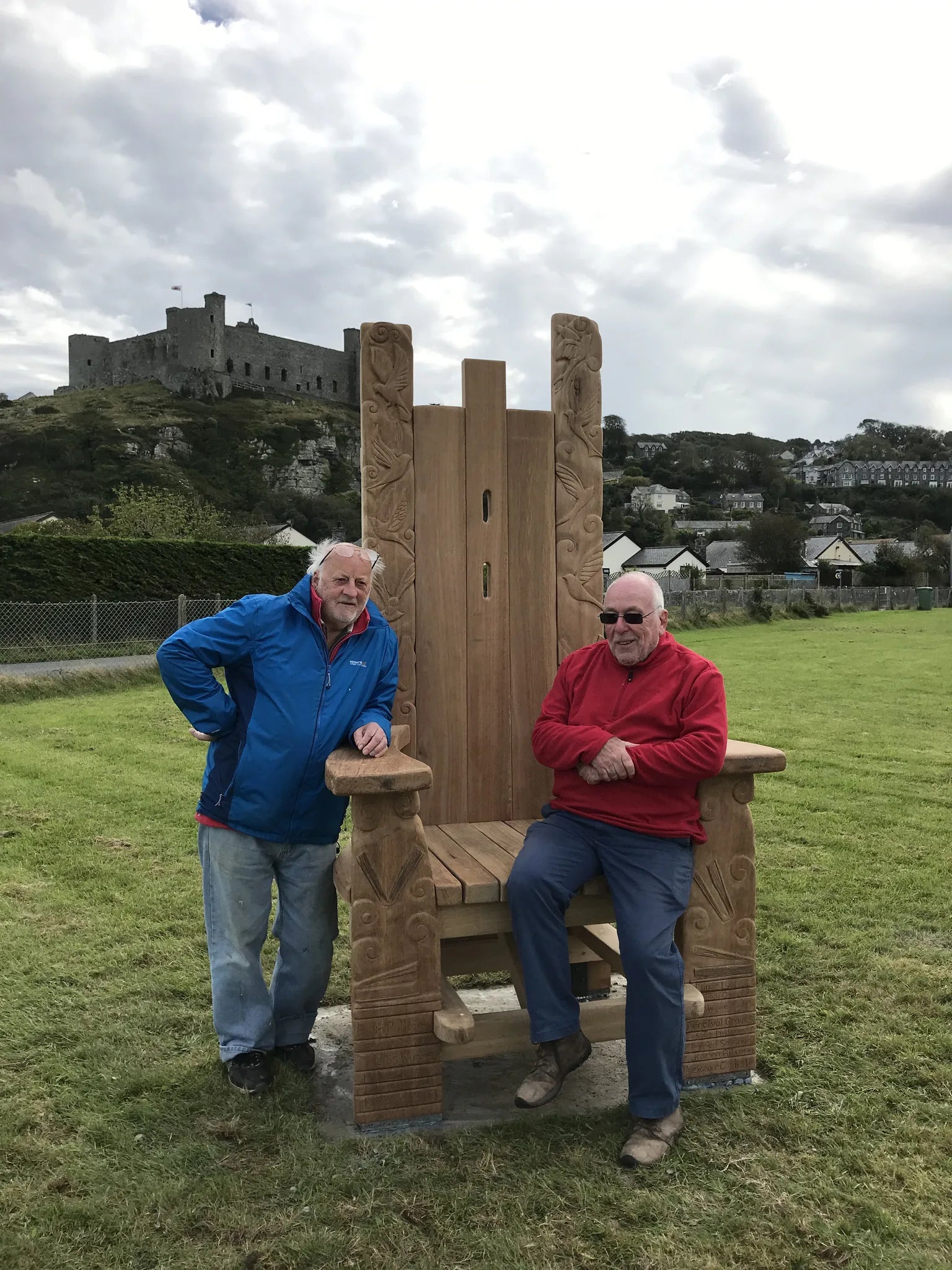 Two craftsmen with the freshly completed Pen Y Graig storytelling throne showing its impressive scale | Harlech Wales