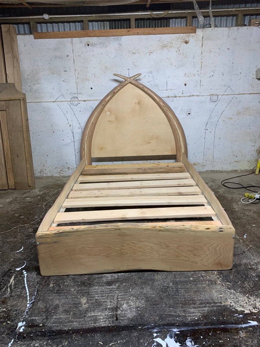 Handmade fantasy wooden arc bed — reclaimed driftwood with tusk-shaped headboard, Wales