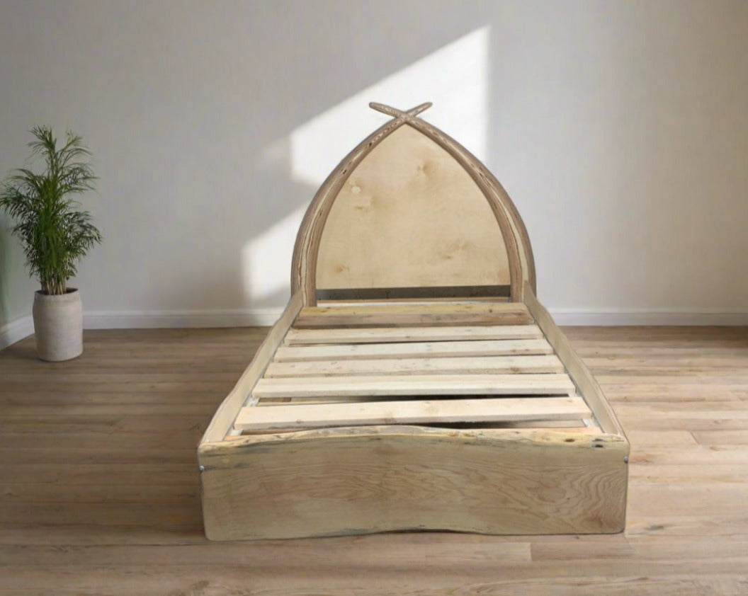 Reclaimed Driftwood Arc Bed with tusk-shaped headboard, crafted from spalted beech driftwood and birch ply, designed for a unique and magical bedroom centerpiece.