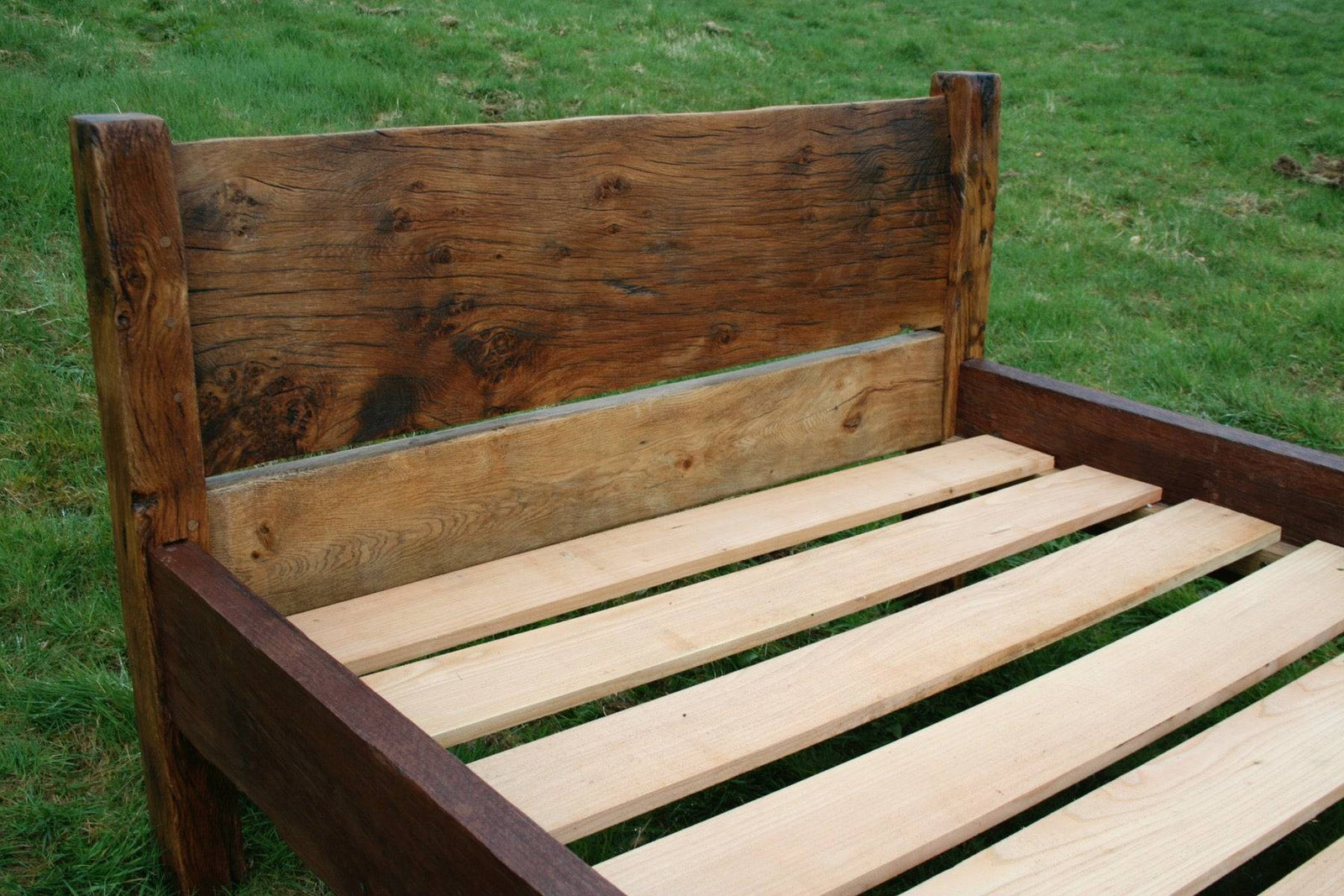 Side view of handmade reclaimed oak bed frame — bespoke, Wales