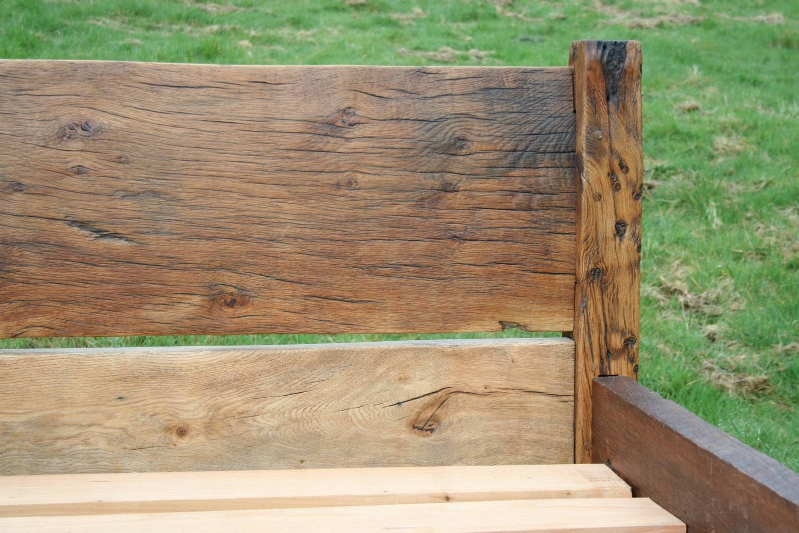 Handmade reclaimed oak bed with visible natural wood grain — bespoke, Wales