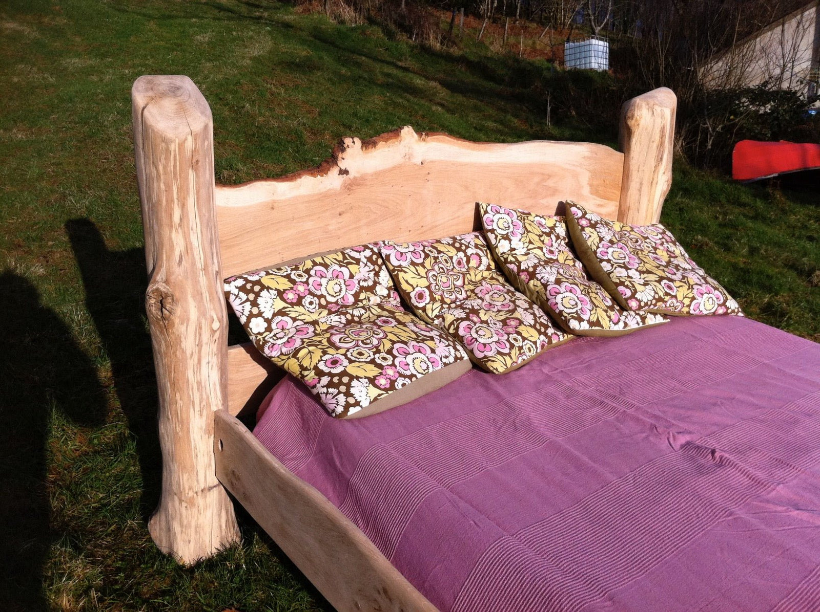 Rustic handmade oak driftwood bed close-up — naturally sourced wood and oak bed frame, Wales