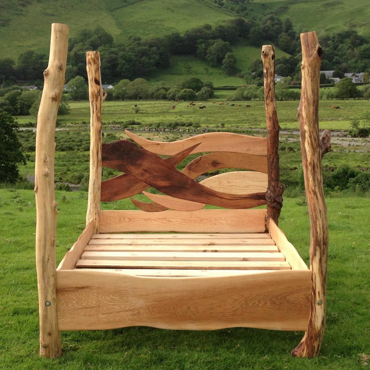 Rustic oak driftwood four-poster bed in scenic landscape
