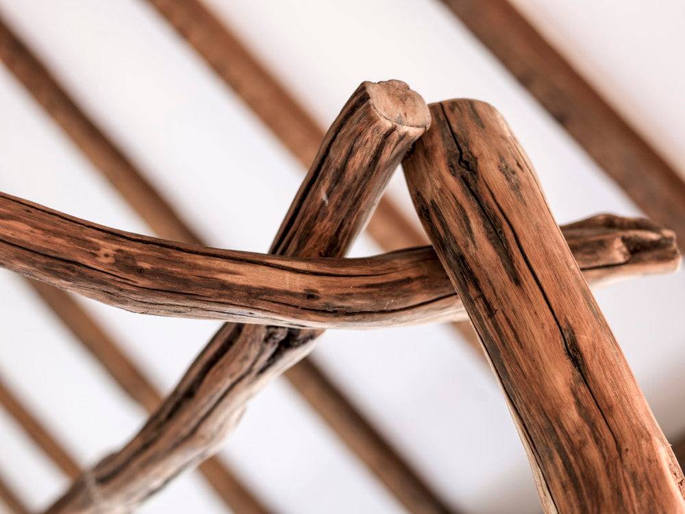 Handmade oak four poster tree bed outdoors — bespoke rustic bedroom furniture, Wales