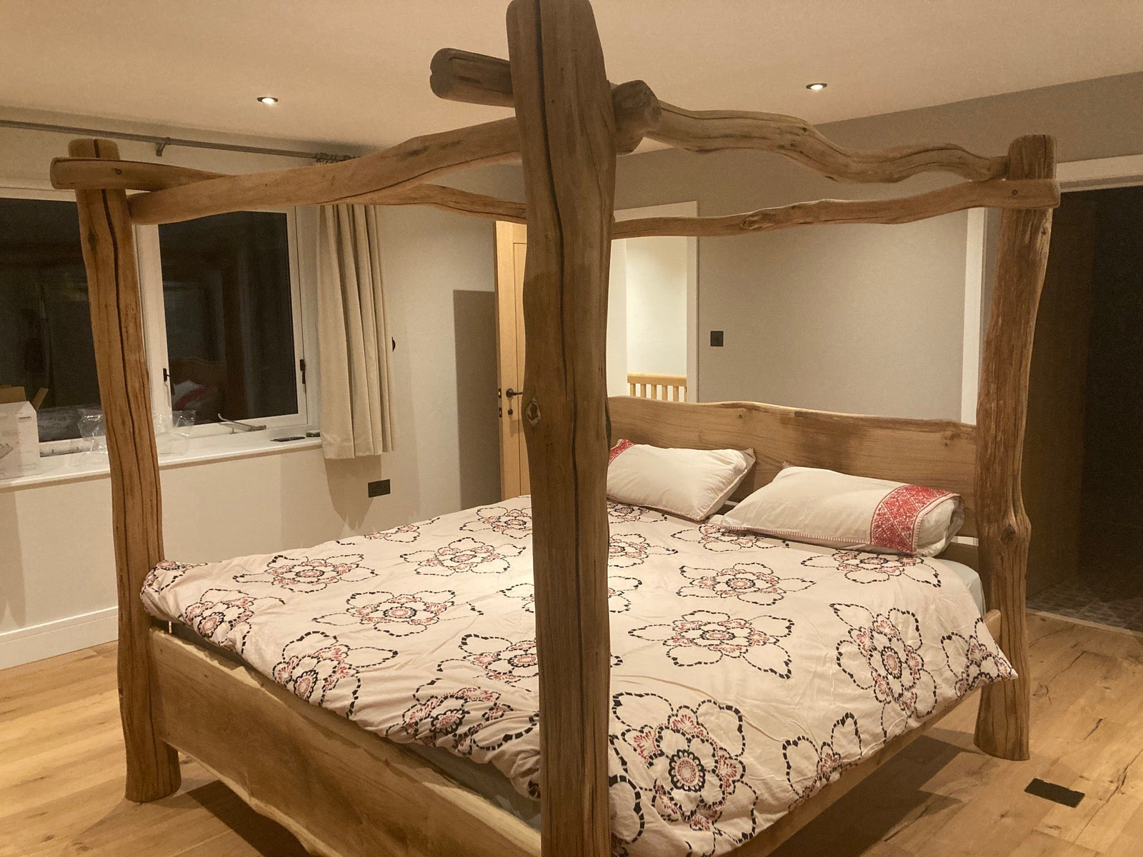 four poster bed frame made from oak in bedroom with mattress