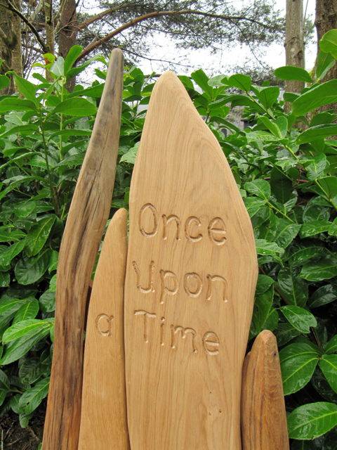 Once upon a time engraving on carved oak storytelling chair — handmade school reading throne, Wales
