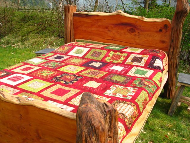 Carved headboard of handmade rustic yew oak bed — bespoke natural wood, Wales